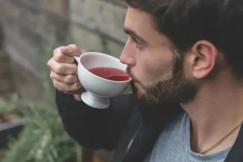 Man drinking herbal tea daily for health benefits and low side effects