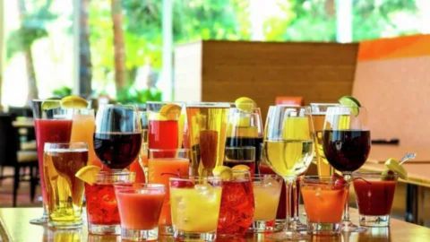 A colorful selection of cocktails, wine, and juices arranged on a table in a bright Las Vegas restaurant, representing bottomless brunch and unlimited drink offers.