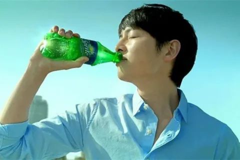 Person drinking a Sprite bottle outdoors, highlighting that Sprite provides quick sugar energy but is not a real energy drink.
